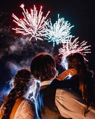 Newlyweds and their daughter watching fireworks at The Ash Barton Estate